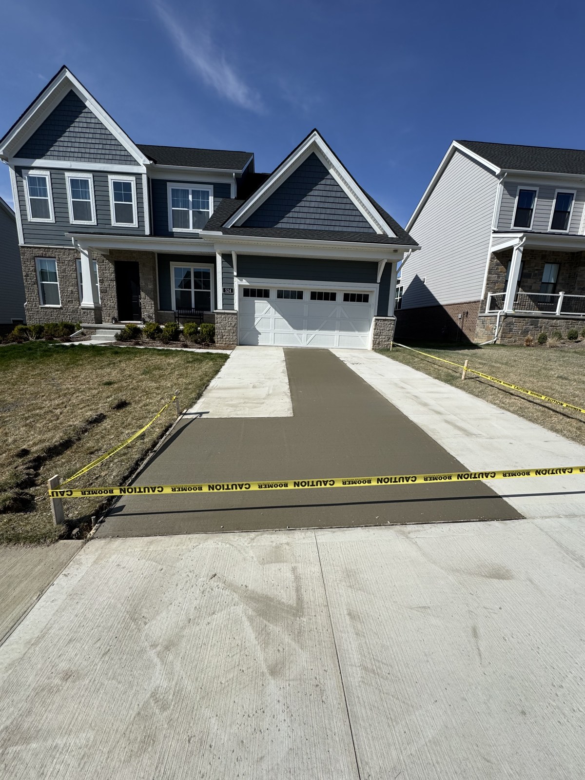 New concrete driveway placed and broom finished at a Southeast Michigan home